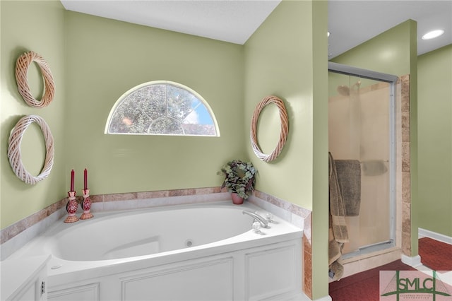 bathroom featuring shower with separate bathtub