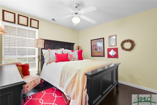 bedroom with ceiling fan and a textured ceiling