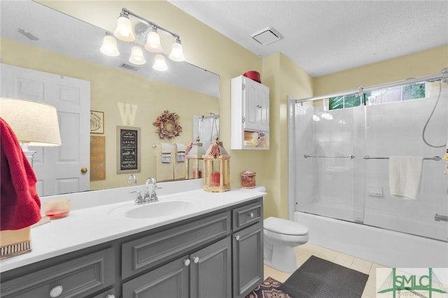 bathroom featuring toilet, vanity, visible vents, and tile patterned floors