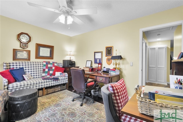 home office with a textured ceiling and ceiling fan