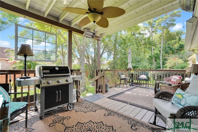 sunroom with plenty of natural light, beam ceiling, and a ceiling fan