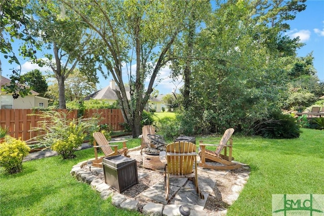 view of yard with a patio area, an outdoor fire pit, and fence