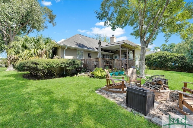 exterior space with a deck and an outdoor fire pit