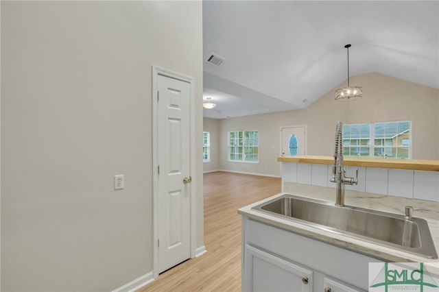 kitchen featuring plenty of natural light, sink, and light wood-type flooring