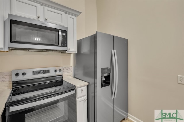 kitchen with appliances with stainless steel finishes and white cabinetry