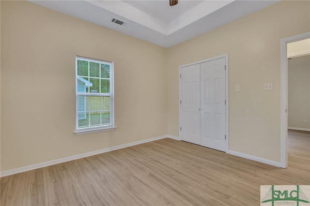 unfurnished bedroom featuring light hardwood / wood-style flooring and a closet