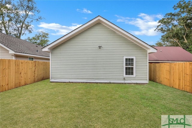 rear view of house featuring a lawn