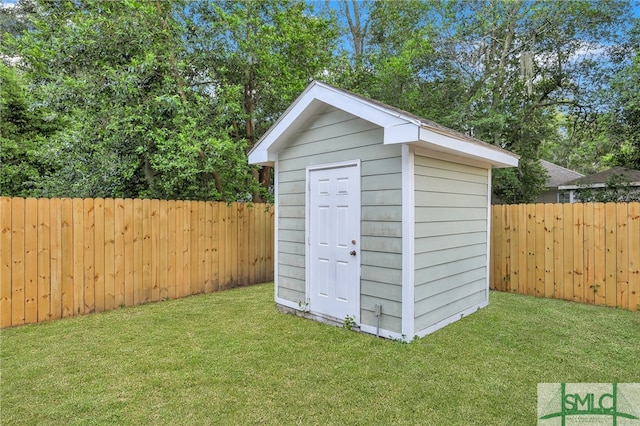 view of outbuilding with a yard