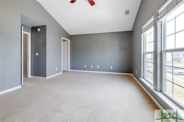 unfurnished room with vaulted ceiling, ceiling fan, and light carpet