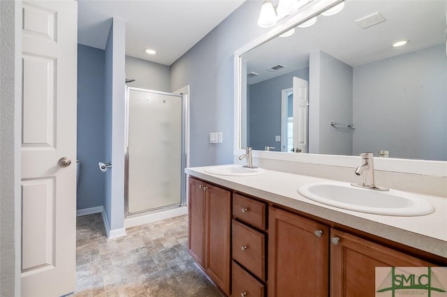 bathroom featuring vanity and an enclosed shower