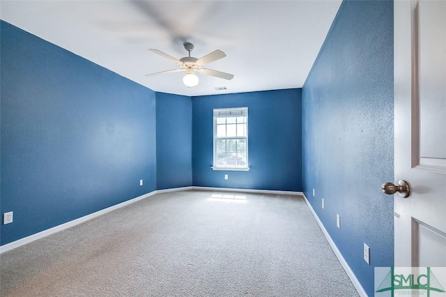 carpeted spare room with ceiling fan