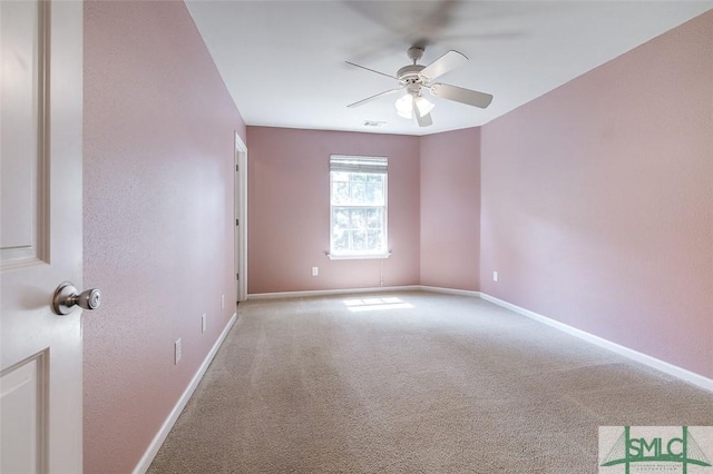 carpeted spare room with ceiling fan