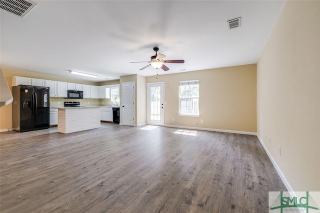 unfurnished living room with light wood-type flooring and ceiling fan