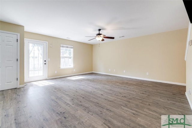 unfurnished living room featuring ceiling fan and hardwood / wood-style floors