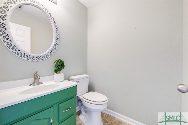 bathroom featuring toilet, vanity, and tile patterned flooring