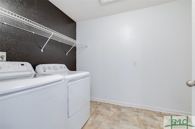 clothes washing area featuring independent washer and dryer and a textured ceiling