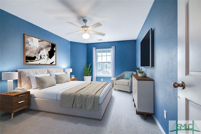 bedroom featuring ceiling fan and light carpet