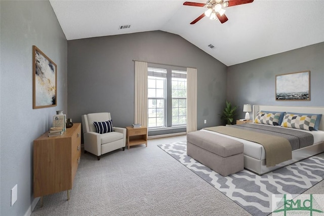 bedroom featuring ceiling fan, vaulted ceiling, and light carpet