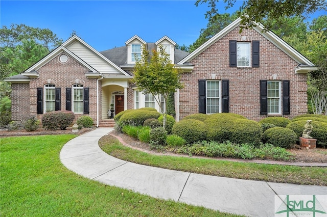 view of property featuring a front lawn