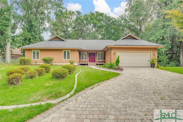 single story home featuring a garage and a front lawn