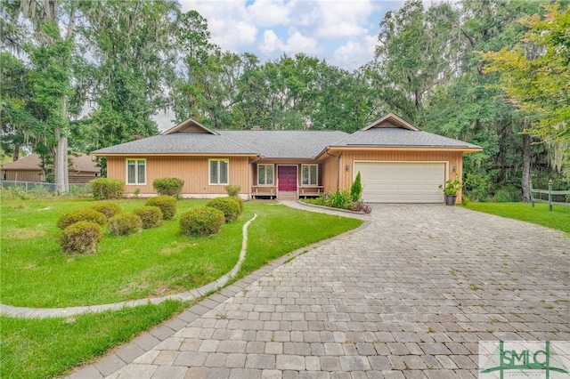 ranch-style house featuring a garage and a front yard