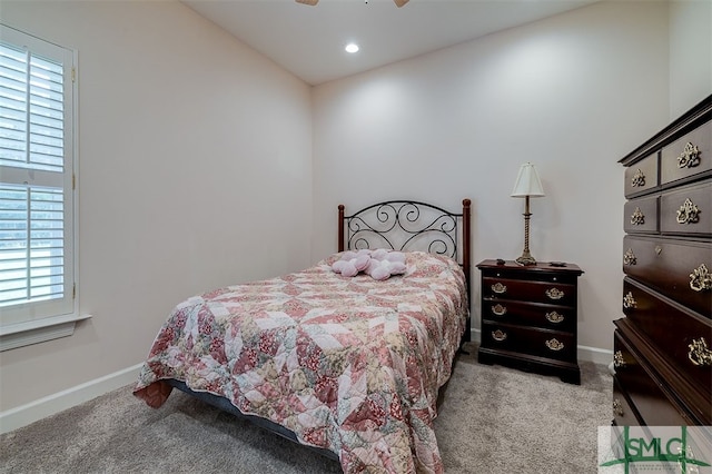 bedroom featuring carpet flooring, ceiling fan, and multiple windows