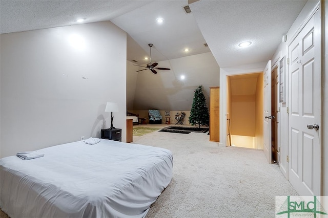 carpeted bedroom with vaulted ceiling, a textured ceiling, and ceiling fan