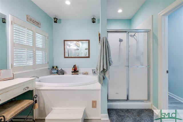 bathroom featuring shower with separate bathtub