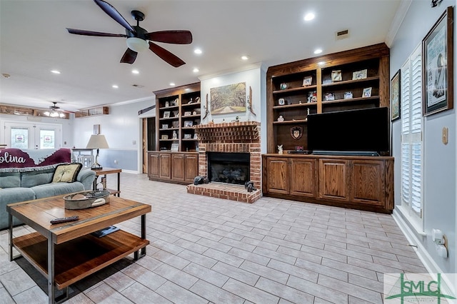 living room with a fireplace, crown molding, and ceiling fan