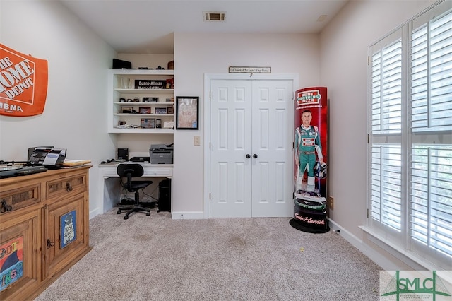 office space with plenty of natural light and carpet flooring