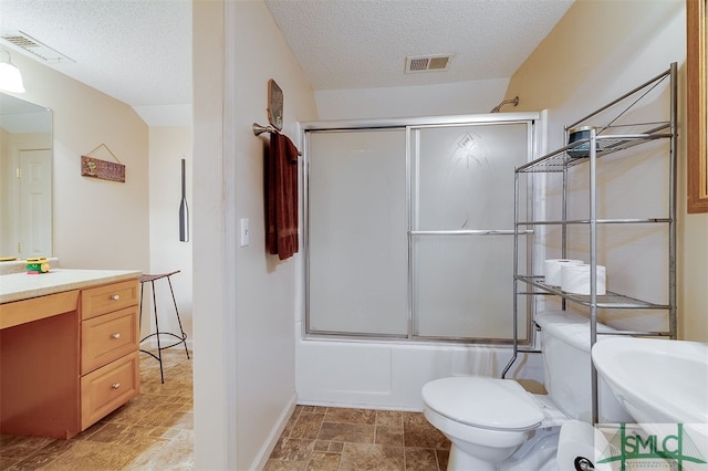 full bathroom featuring vanity, a textured ceiling, toilet, and enclosed tub / shower combo