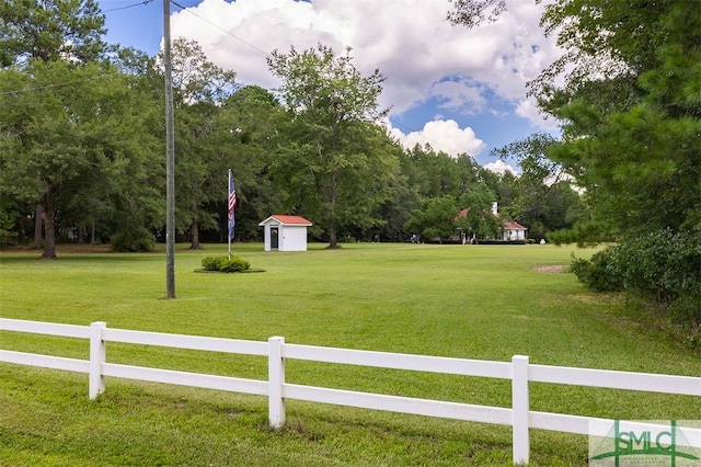 surrounding community featuring a yard and a storage unit