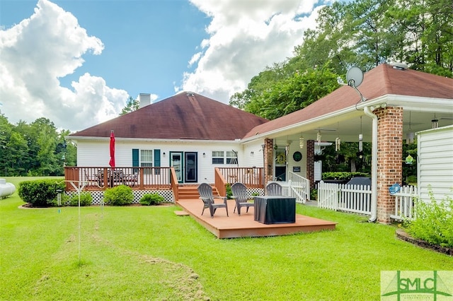 back of house with a yard and a wooden deck