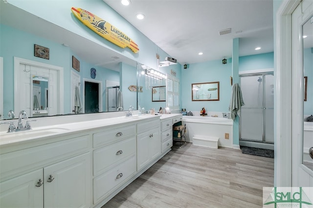 bathroom featuring vanity, a shower with shower door, and hardwood / wood-style flooring