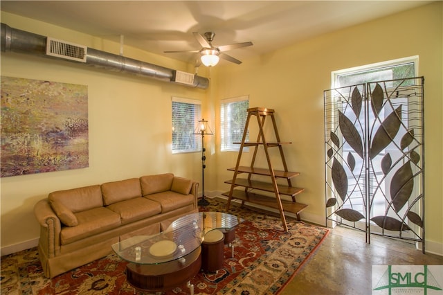 living room with concrete floors, plenty of natural light, and ceiling fan