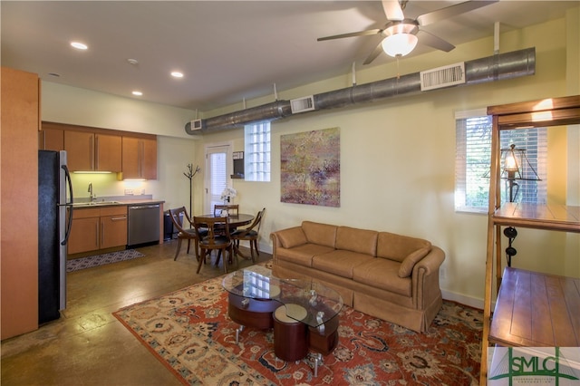 living room with ceiling fan and sink