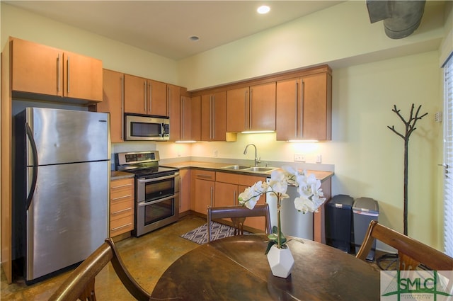 kitchen featuring sink, concrete flooring, and stainless steel appliances