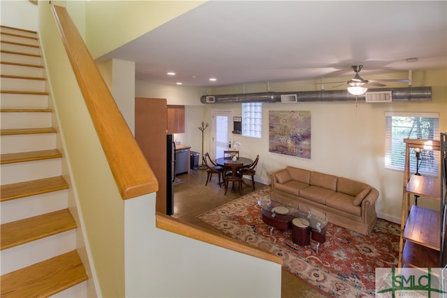 living room with ceiling fan and hardwood / wood-style flooring