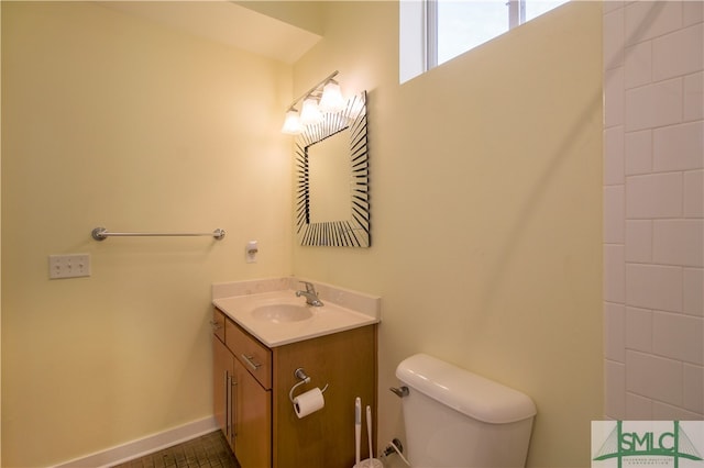 bathroom with vanity, toilet, and tile patterned flooring