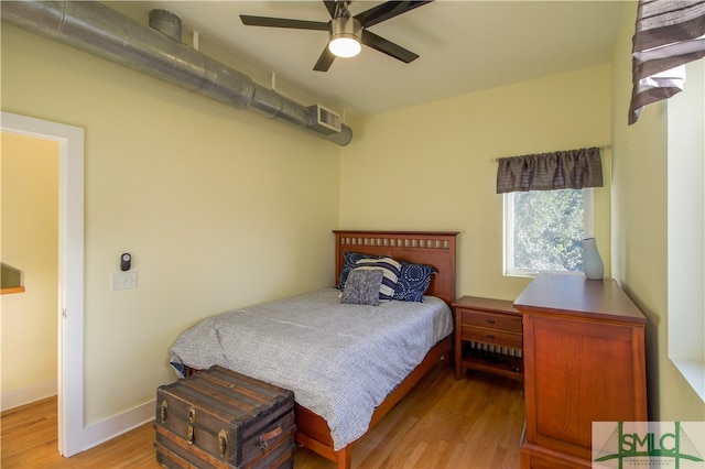 bedroom with light hardwood / wood-style flooring and ceiling fan