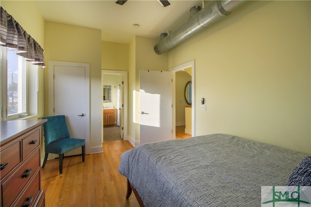 bedroom with ceiling fan, light hardwood / wood-style floors, and ensuite bath