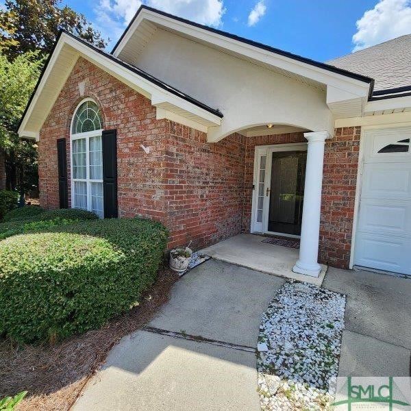 view of exterior entry with a garage