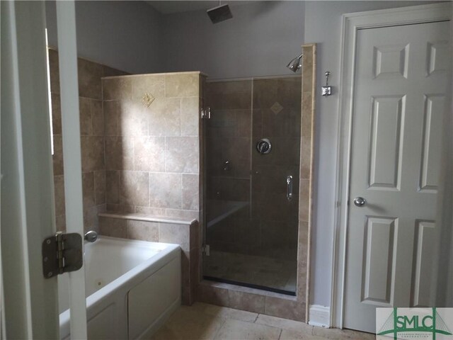 bathroom featuring tile patterned floors and separate shower and tub