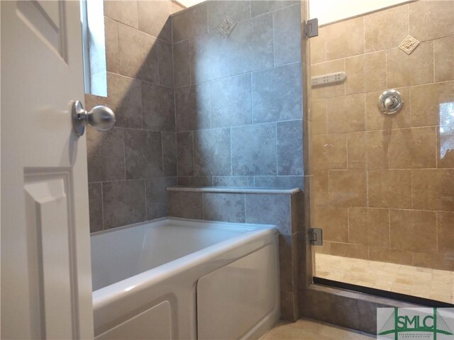 bathroom with separate shower and tub