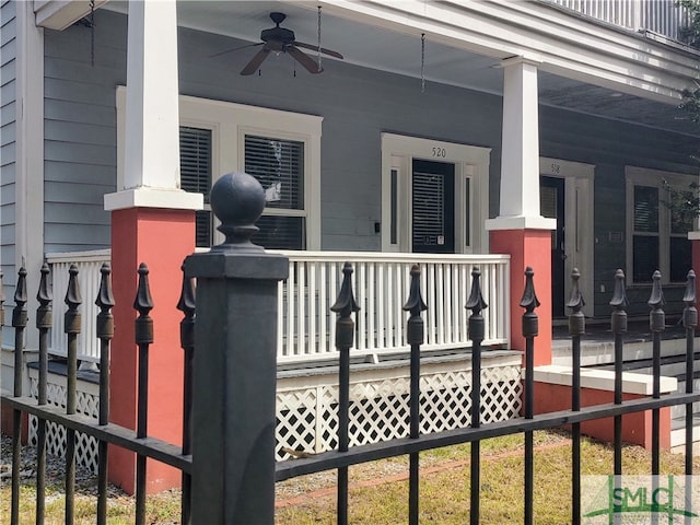 view of gate featuring ceiling fan and covered porch