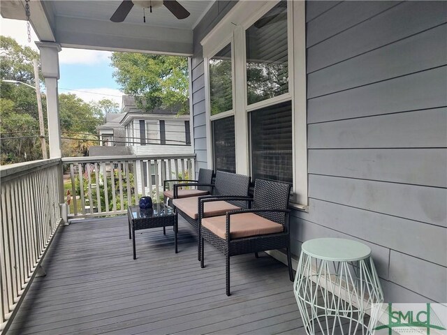 wooden terrace featuring ceiling fan and covered porch