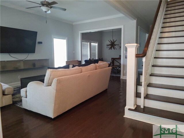 living room with ceiling fan, ornamental molding, and dark wood-type flooring