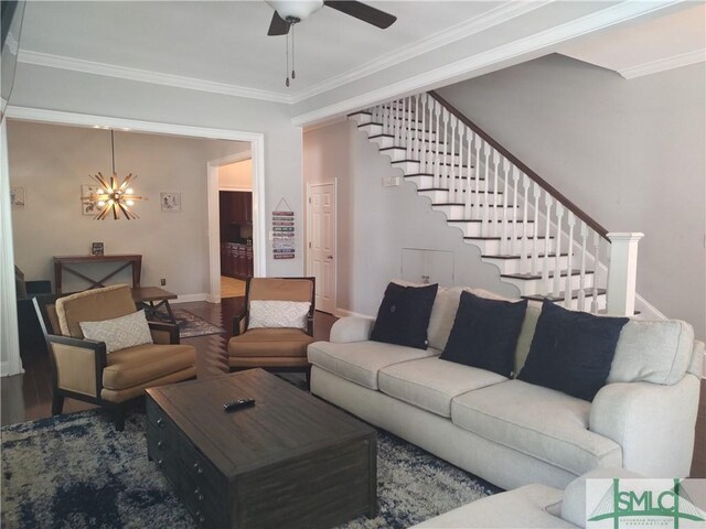 living room with ceiling fan with notable chandelier, wood-type flooring, and crown molding