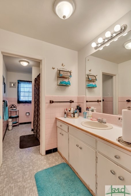 bathroom with vanity and tile walls