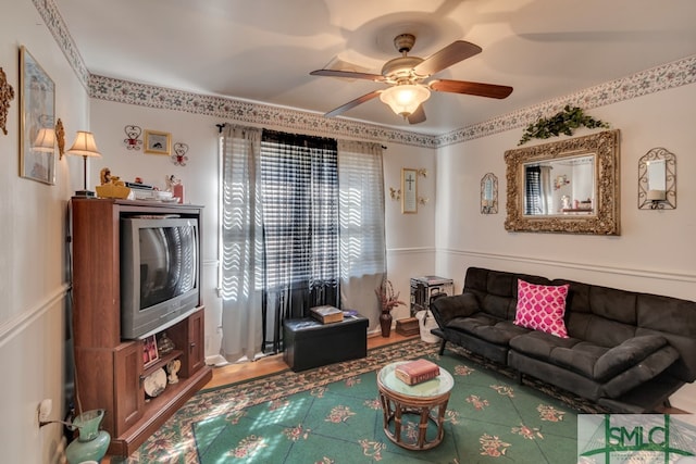 living room featuring ceiling fan and hardwood / wood-style floors